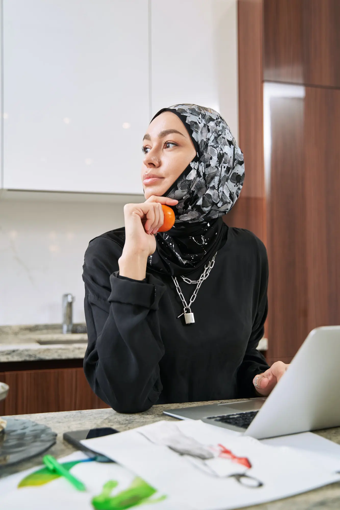 Happy muslim woman studying with laptop at home